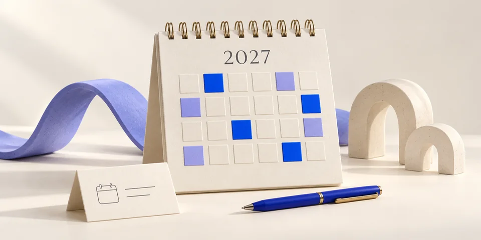 A sculptural 2027 planner with abstract coloured tiles, a leave-request card and a blue pen.